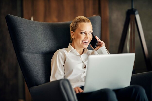 A busy woman is sitting in a hotel room during her business trip