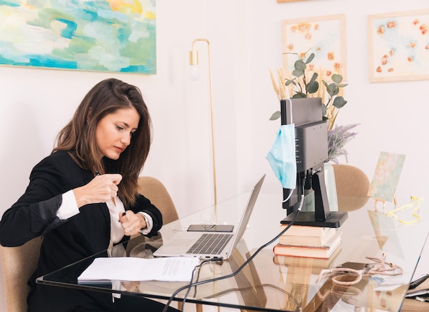 Busy woman working in home office during coronavirus pandemic