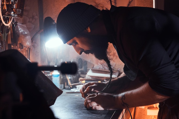 In the busy workshop a talanted master is working on his new project.