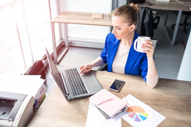 Busy and young woman is working