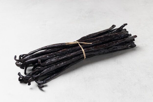 Photo butch of vanilla beans on light background