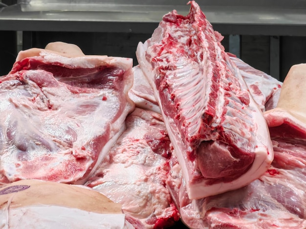 butcher cuts raw meat into pieces