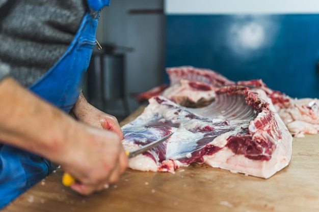 A butcher preparing fresh pork at the slaughterhouse