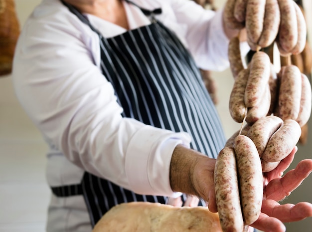 Butcher selling sausages on a string