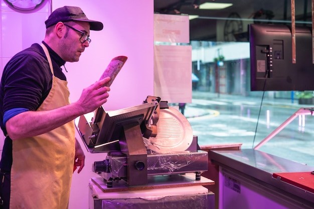 Butcher Showing Pork Loin to Customer