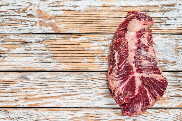 Butchers choice steak Onglet Hanging Tender beef meat on a cutting board. White wooden background. Top View. Copy space.