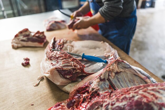 Butchers job cutting pig meat at the slaughterhouse