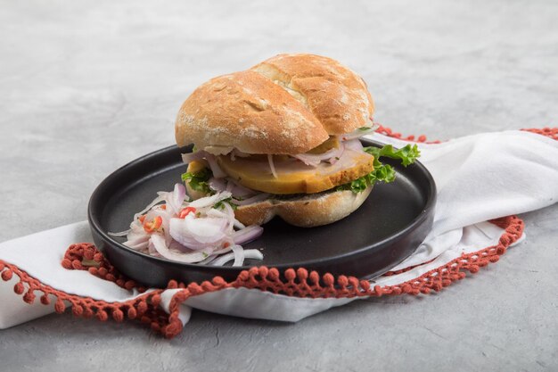 Butifarra peruvian traditional ham sandwich with salad and lettuce