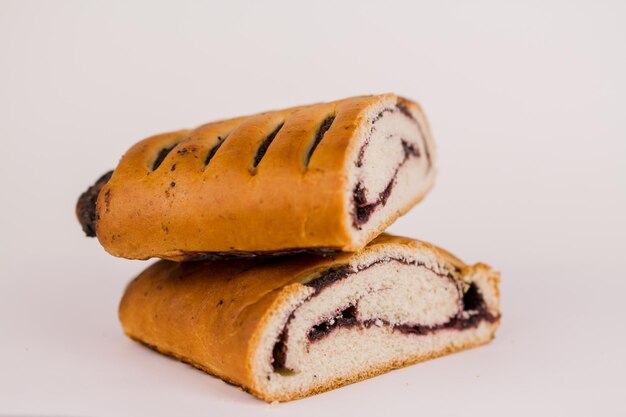 A butter bun with poppy seeds on a white plate