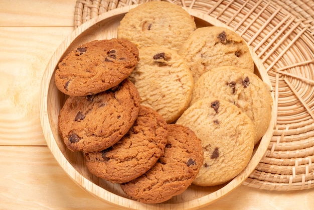 Butter cookies in wooden plate on wooden background chocolate\
chip cookies ready to serve