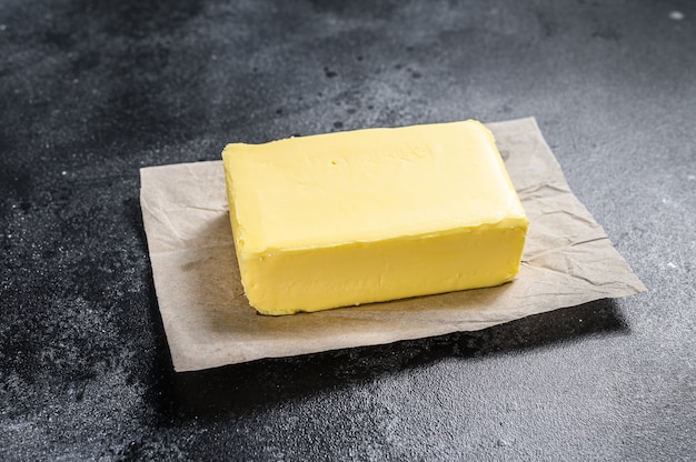 Butter on craft paper on Black table.