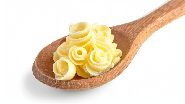 Butter curls or butter rolls on wooden spoon isolated