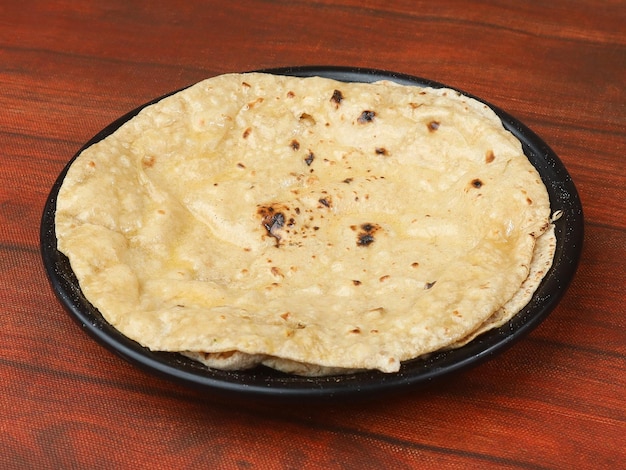 Butter naan isolated over a rustic wooden background selective focus