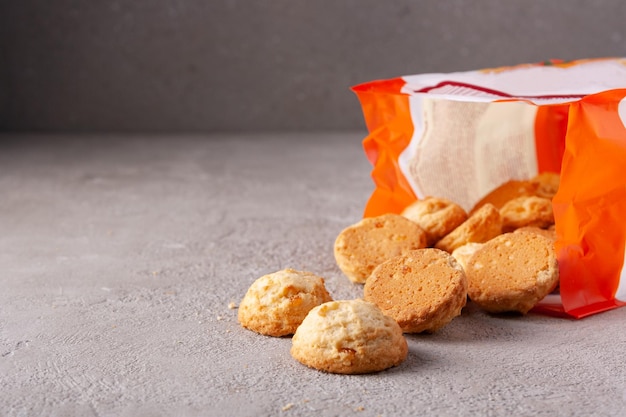 Butter round biscuits spill out of the package copy space