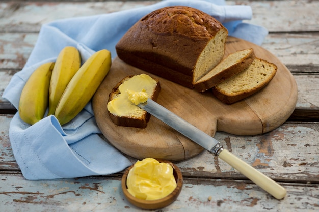 Butter spread on bread slice and bananas