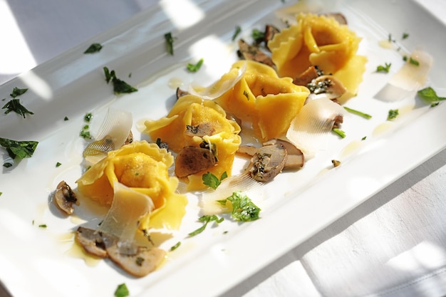 Butter tortellini with mushrooms and parmesan cheese