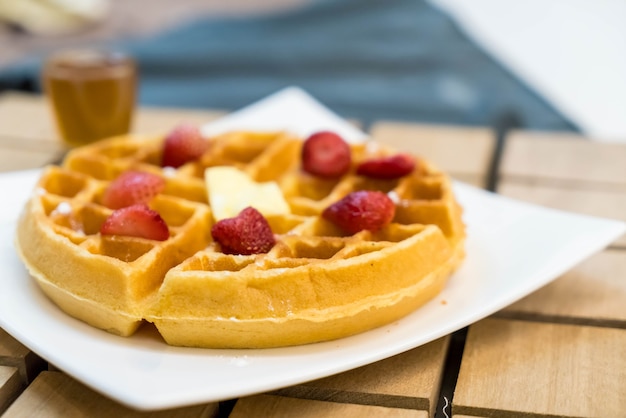 butter waffle with honey and strawberry