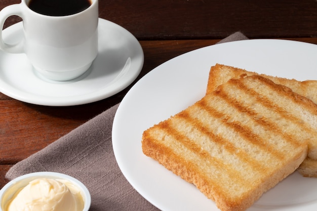 Buttered toast bread with black coffee.