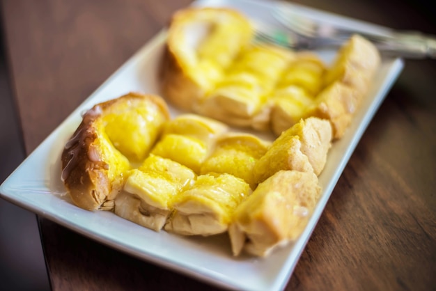 Buttered toast on the wooden table in the cafe.