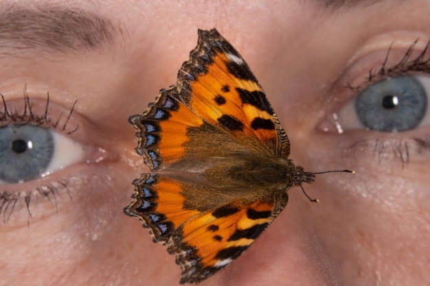 a butterfly sits on a woman's body