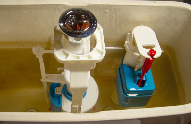 Photo a button fixture or mechanism in an old toilet drain. repair for the correct discharge of water.