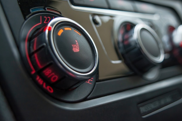 Button for heating the car seats close-up.