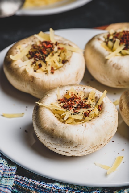 Button mushrooms stuffed with grated cheddar cheese and spices