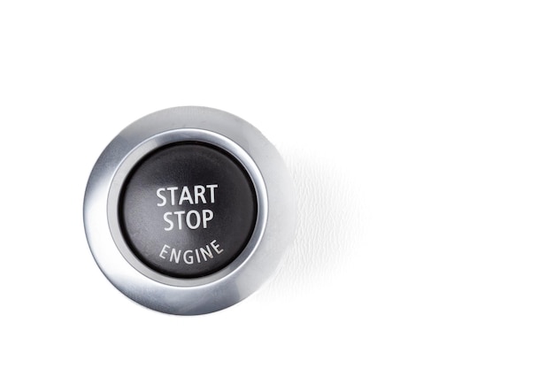 Photo button start and turn off the ignition of the car engine closeup on the dashboard electric key pressing drives the motor vehicle of modern design on white isolated background