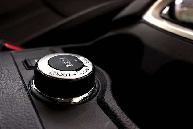 Button switches control for car with soft-focus and over light in the background