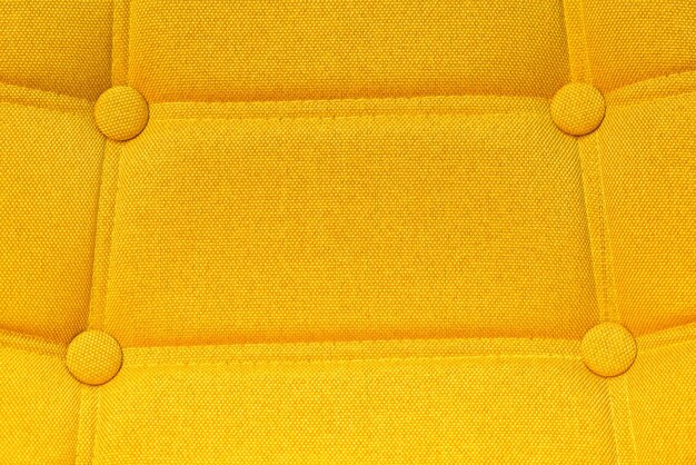 Photo buttoned yellow chair back support detail