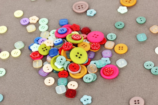 Photo buttons of different shapes sizes and colors closeup on gray background