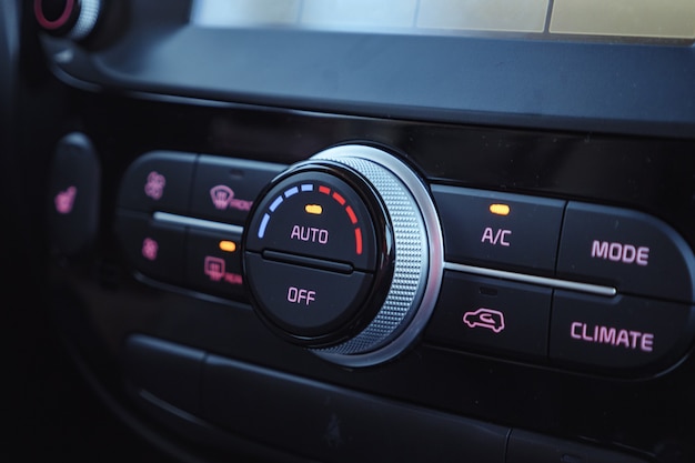 Photo buttons of radio, dashboard, climate control in car close up