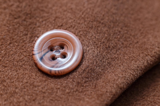 Buttons on wool coat Clothes repair Closeup button