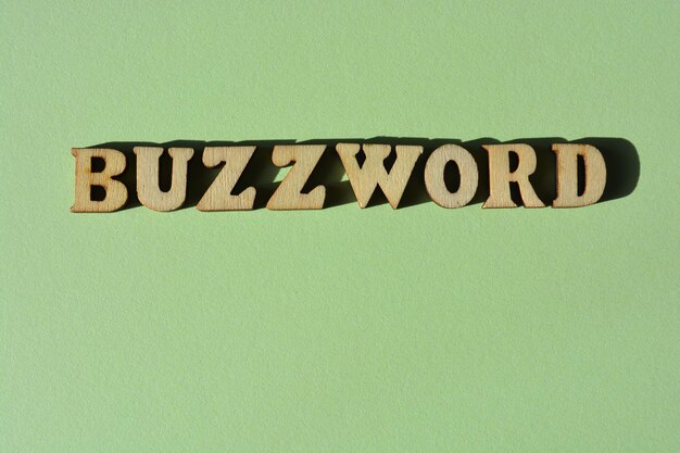 Buzzword word in wooden alphabet letters isolated on green background