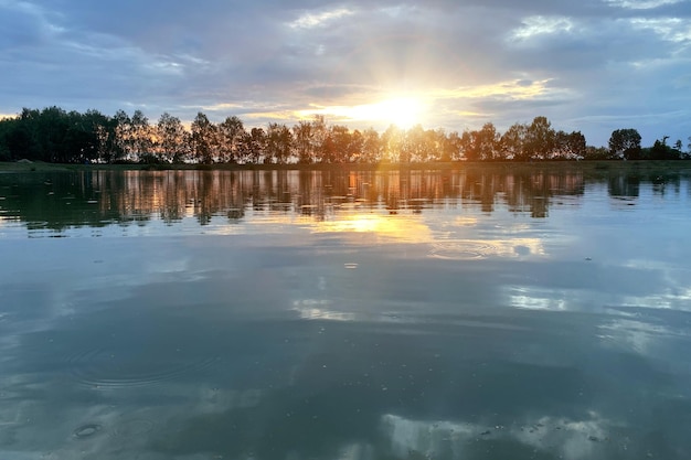 By the lake in the evening at sunset