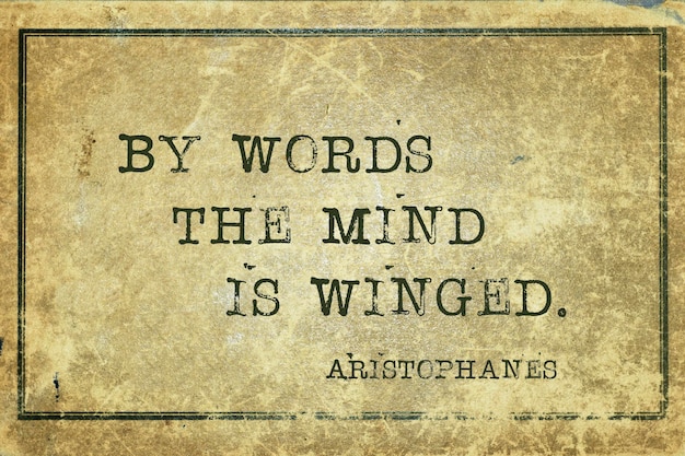 By words the mind is winged - famous ancient Greek comic playwright Aristophanes quote printed on grunge vintage cardboard