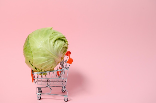 Cabbage in a basket on a pink background