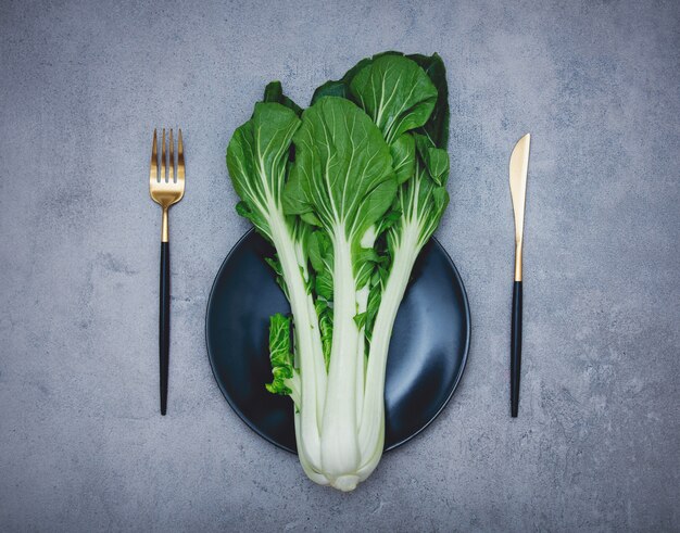 Cabbage on a plate with fork and knife.