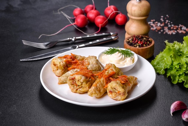 Cabbage rolls stuffed with ground beef and rice served on a white plate