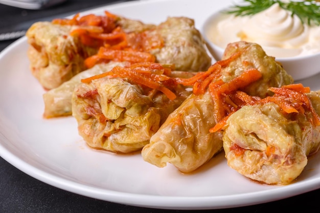 Cabbage rolls stuffed with ground beef and rice served on a white plate