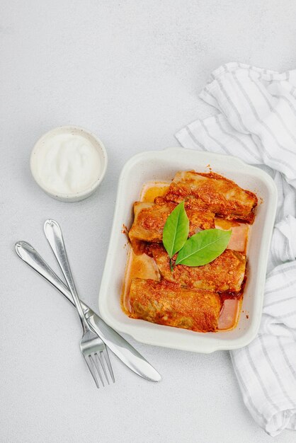 Cabbage rolls stuffed with rice and meat stewed in tomato sauce