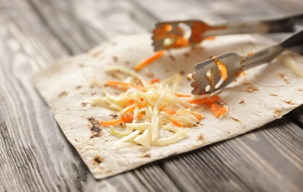 Cabbage salad on lavash on wooden backgroundphoto with copy space