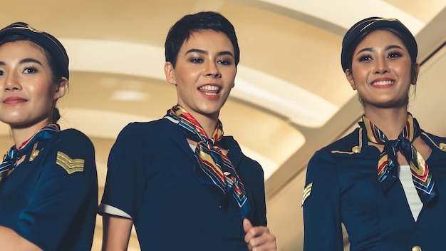 Cabin crew dancing with joy in airplane 