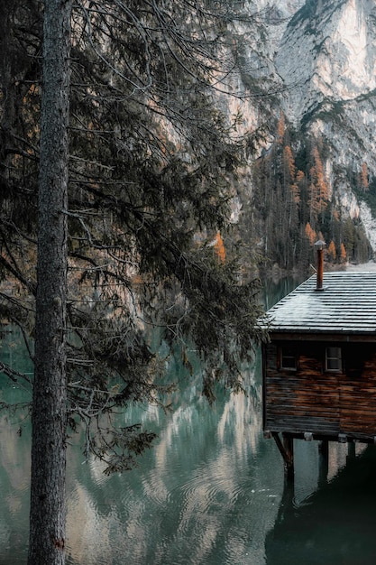 a cabin is surrounded by a mountain with a cabin on the water