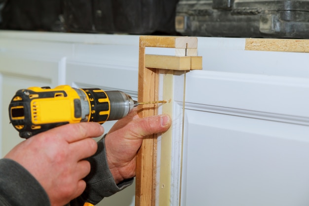 Cabinet door master drills the door in the cabinet door