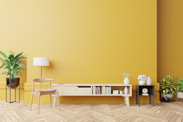 cabinet for tv in modern living room with lamp, table, flowers and plant on yellow wall