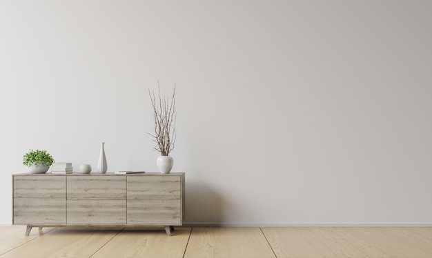 Cabinet with plant and door in front of white  wall.