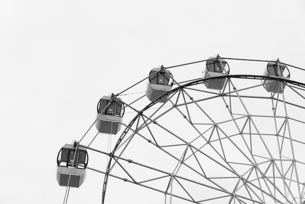 The cabins of a ferris wheel in a deserted attraction park