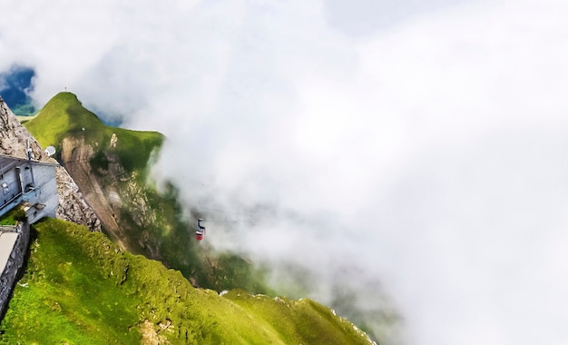  cable car climbing up Steep Cliff in thick fog