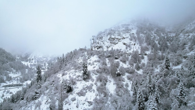 Cable car in the mountains in the winter forest